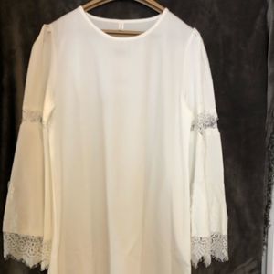 Beautiful white Lacey blouse with flared sleeves